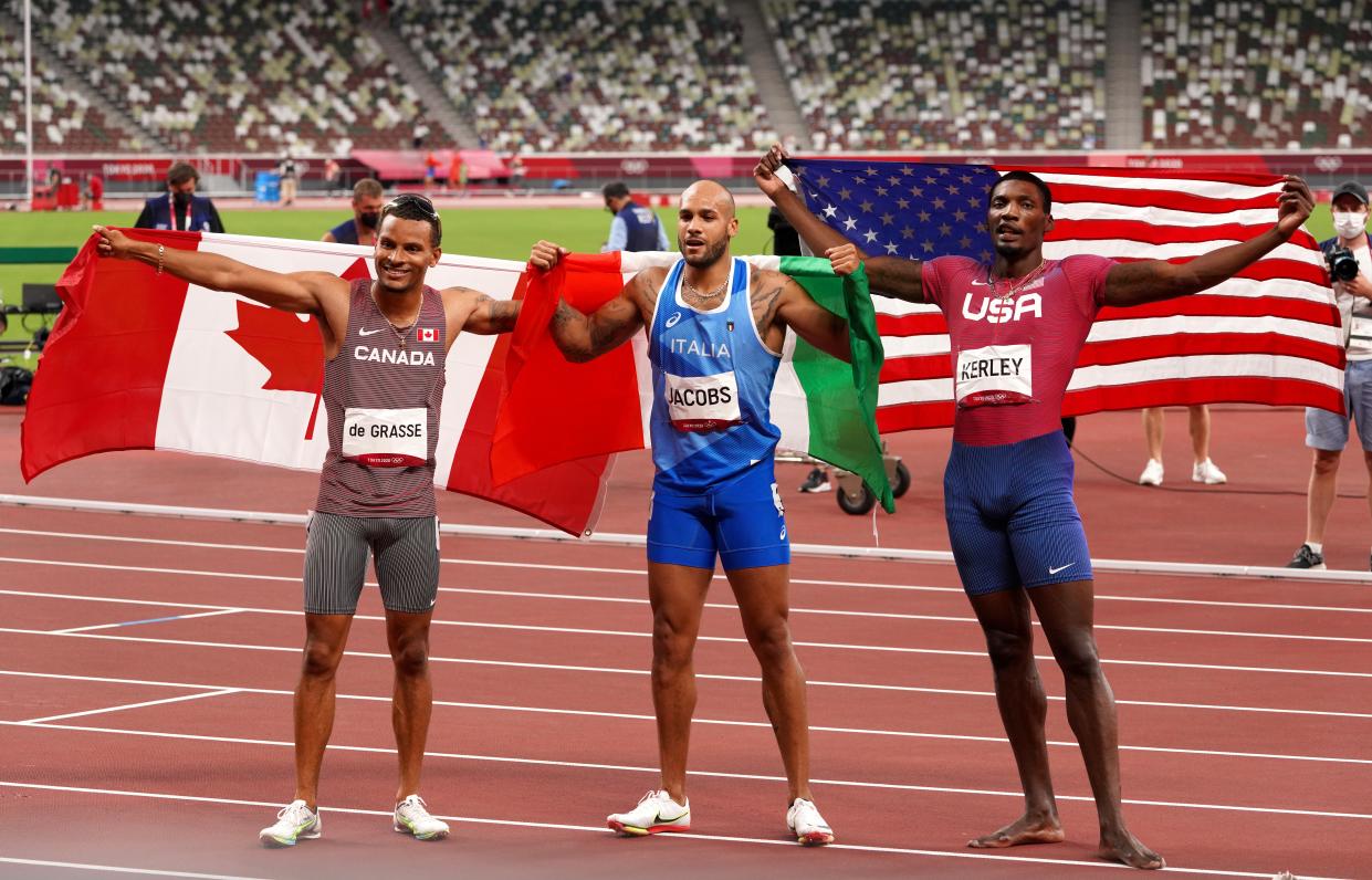 Jacobs, Kerley and De Grasse celebrate after the 100m in Tokyo. (Martin Rickett/PA) (PA Wire)