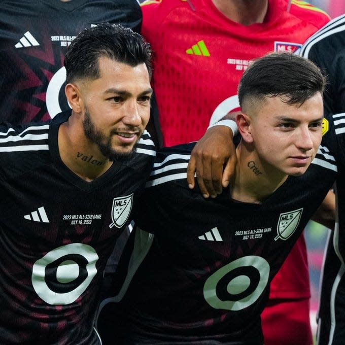 FC Cincinnati's Luciano Acosta (left) and Alvaro Barreal (right) pose with other members of the MLS All-Star team starting lineup