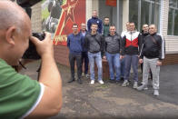 In this photo made from footage provided by the Russian Defense Ministry on Wednesday, July 15, 2020, a group of volunteers participating in a trial of a coronavirus vaccine pose for a photo as they leave the Budenko Main Military Hospital outside Moscow, Russia. Russia is boasting that it’s about to be the first country to approve a COVID-19 vaccine, but scientists worldwide are sounding the alarm that the headlong rush could backfire. (Russian Defense Ministry Press Service via AP)