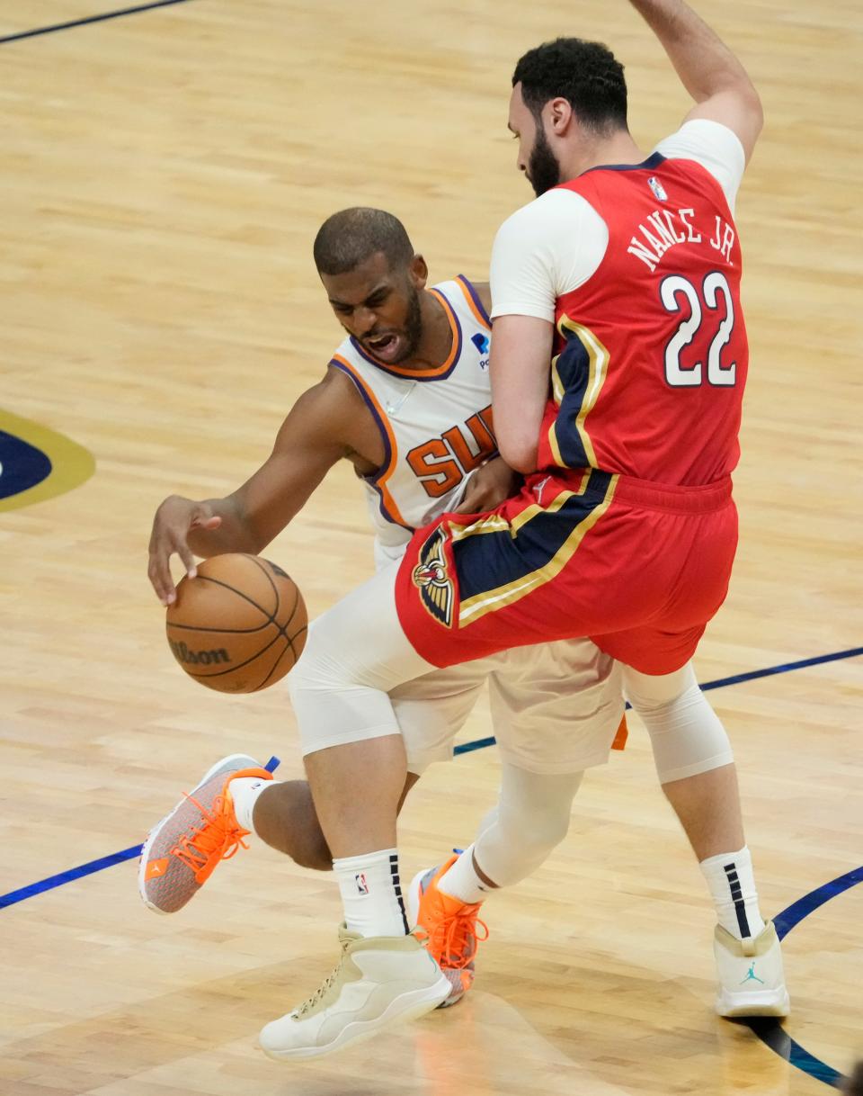 Apr 22, 2022; New Orleans, Louisiana, U.S.;  Phoenix Suns guard Chris Paul (3) is fouled by New Orleans Pelicans forward Larry Nance Jr. (22) during Game 3 of the Western Conference playoffs. Mandatory Credit: Michael Chow-Arizona Republic