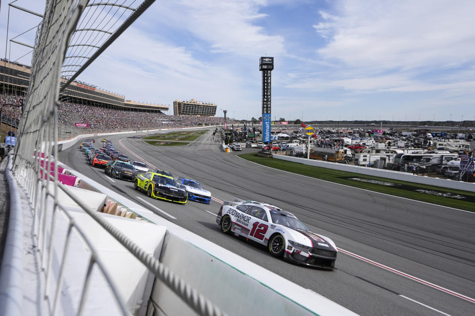 Ryan Blaney (12) drives into a turn during the NASCAR auto race at Atlanta Motor Speedway Sunday, Feb. 25, 2024, in Hampton, Ga. (AP Photo/John Bazemore)