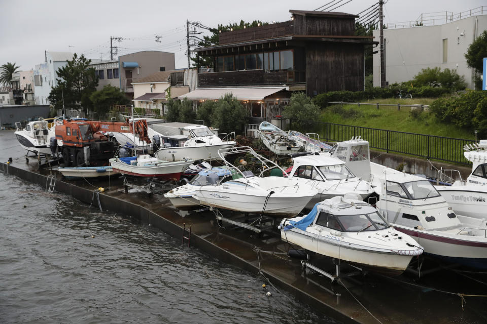 Boats are removed from the water in preparation for Typhoon Hagibis in Kamakura, west of Tokyo, Friday, Oct. 11, 2019. A typhoon was forecast to bring 2 feet of rain and damaging winds to the Tokyo area and central Japan's Pacific coast this weekend, and the government warned people Friday to stockpile and leave high-risk places before it's too dangerous. (AP Photo/Jae C. Hong)