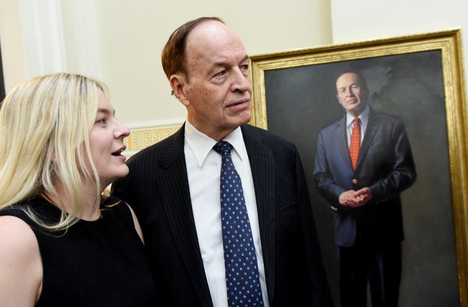 Former Senator Richard Shelby stands in front of his official portrait with his granddaughter Anna Shelby after the ceremony naming the federal courthouse in Tuscaloosa the Richard Shelby Federal Building and Courthouse Friday, Sept. 15, 2023.