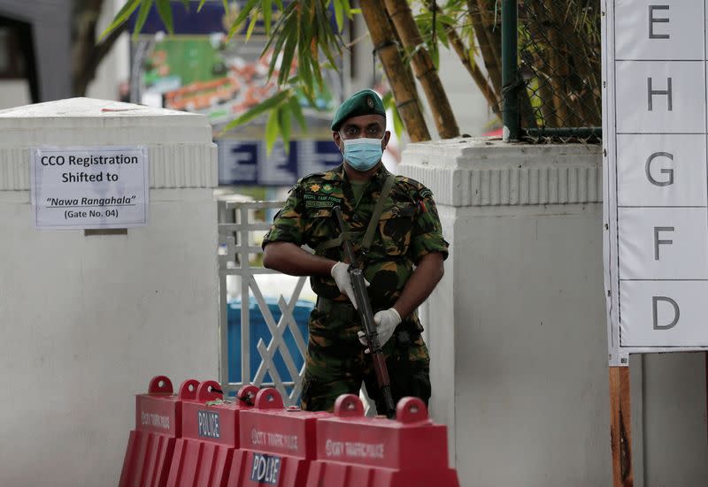 A Special Task Force member stands guard in front of a counting center on the following day of the country's parliamentary election in Colombo