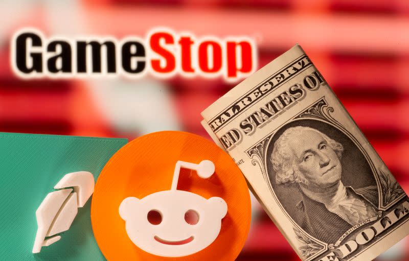 FILE PHOTO: A 3d printed Robinhood and Reddit logos are seen near one dollar banknotes in front of displayed GameStop logo