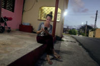 Dayali Lopez connects her mobile device to the internet in Varadero, Cuba, December 6, 2018. Picture taken December 6, 2018. REUTERS/Fernando Medina