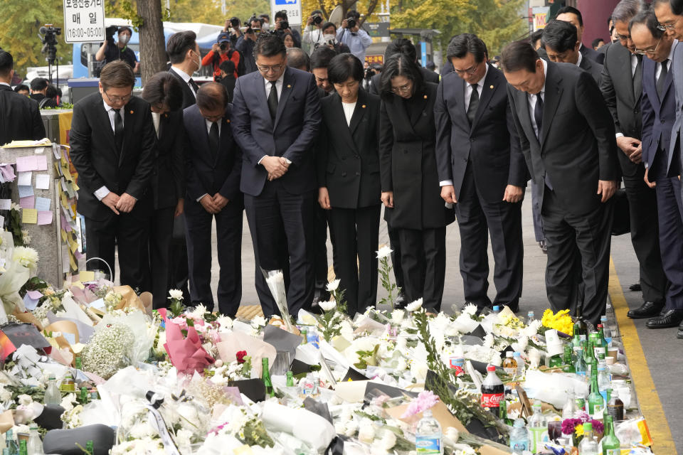 South Korean President Yoon Suk Yeol, third from right, and cabinet members pay tribute to victims of a deadly accident following Saturday night's Halloween festivities on a street near the scene in Seoul, South Korea, Tuesday, Nov. 1, 2022. (AP Photo/Ahn Young-joon)