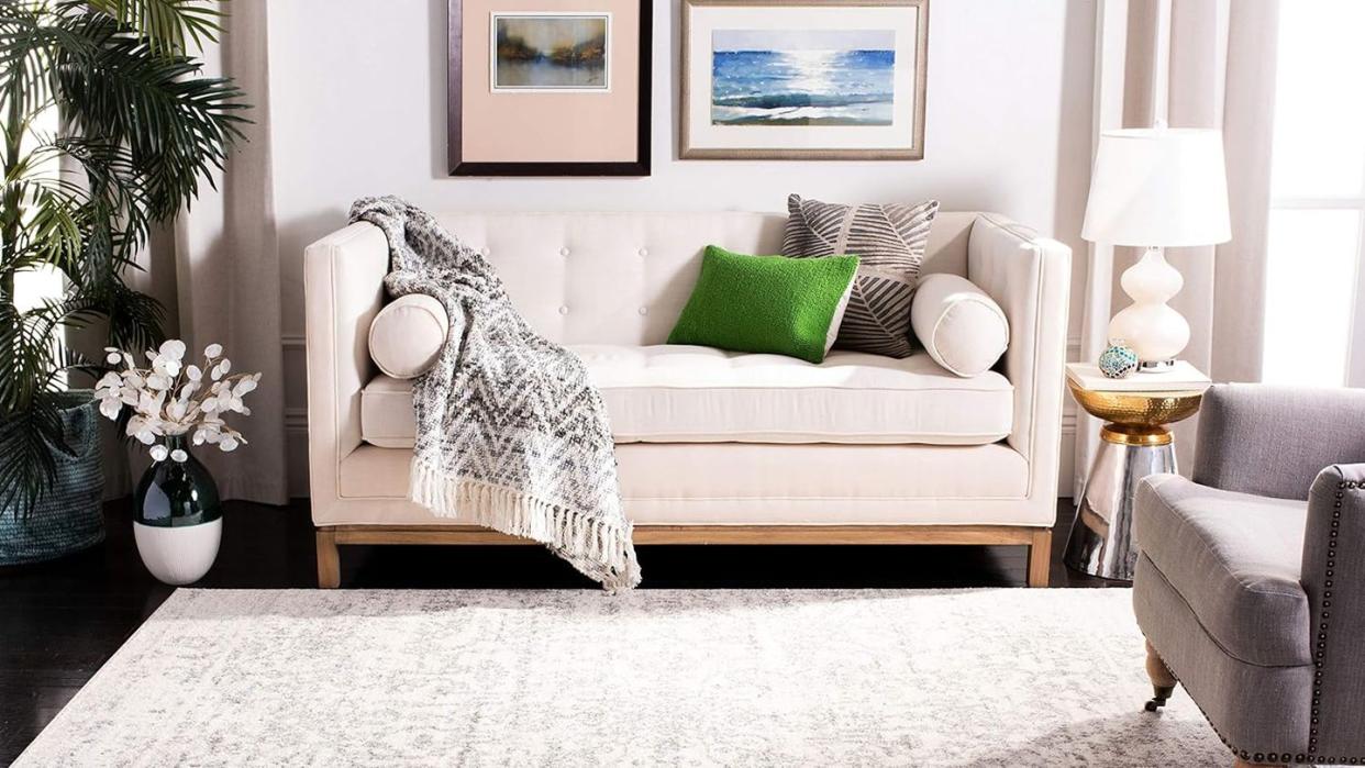 a white couch with a blanket on it