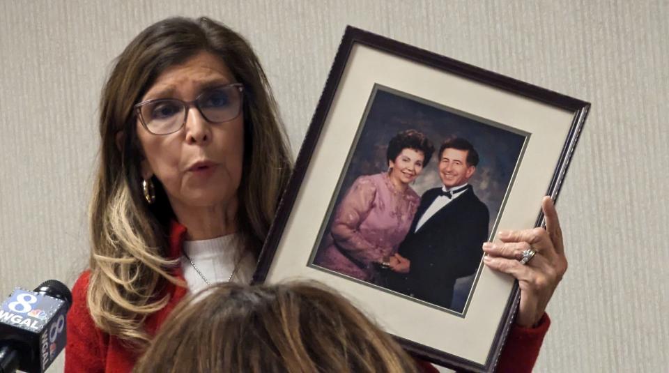 Delma Rivera-Lytle holds a picture up of her parents who are buried at Prospect Hill Cemetery as she addresses the supervisors at Tuesday's meeting.