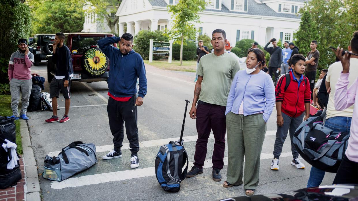 Migrants, who arrived on a flight sent by Florida Gov. Ron DeSantis, gather with their belongings outside St. Andrews Episcopal Church, Wednesday, Sept. 14, 2022, in Edgartown, Mass., on Martha's Vineyard. 