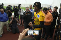 Washington Commanders first round draft pick quarterback Jayden Daniels talks with reporters following an NFL rookie minicamp football practice in Ashburn, Va., Friday, May 10, 2024. (AP Photo/Susan Walsh)