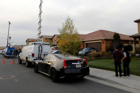 Neighbors stand and watch news crews outside the home of David Allen and Louise Anna Turpin in Perris, California, U.S., January 15, 2018. REUTERS/Mike Blake