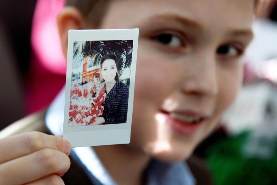 Luke Wheeler-Waddison holds his photo of Kate Middleton | Toby Melville - WPA Pool/Getty