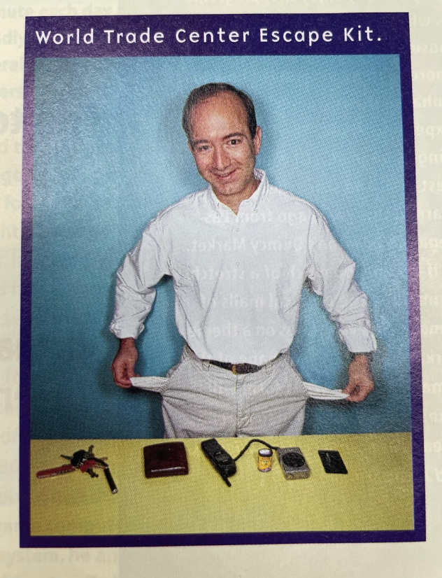 Man in white shirt displaying survival items labeled "World Trade Center Escape Kit."