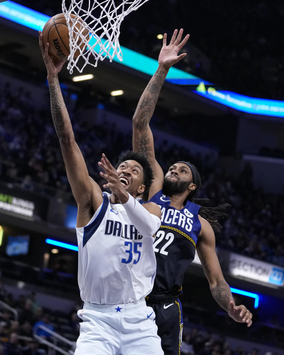 Dallas Mavericks forward Christian Wood (35) shoots in front of Indiana Pacers forward Isaiah Jackson (22) during the first half of an NBA basketball game in Indianapolis, Monday, March 27, 2023. (AP Photo/Michael Conroy)