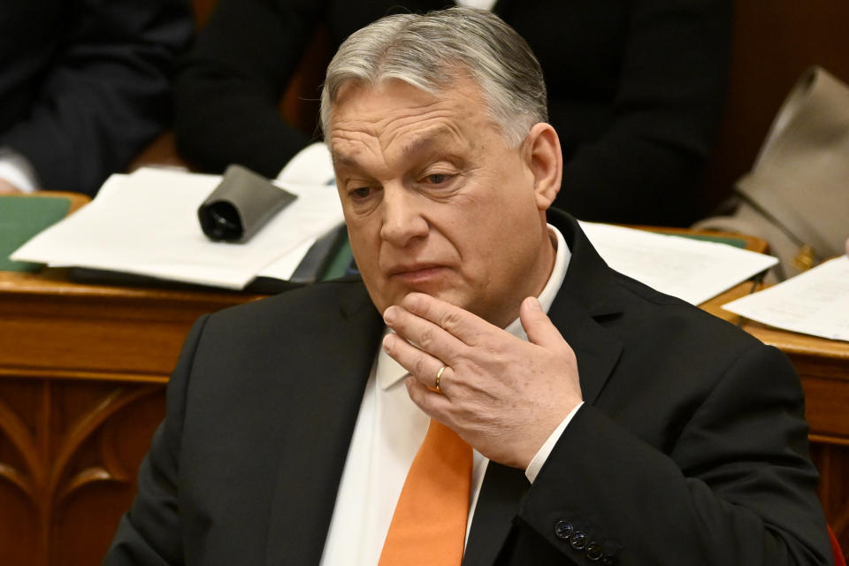 Hungarian Prime Minister Viktor Orban touches his face after addressing a parliament session, on the day lawmakers are expected to approve Sweden's accession into NATO, in Budapest, Hungary, Monday, Feb 26, 2024. Hungary's parliament is to vote Monday on ratifying Sweden's bid to join NATO, likely bringing an end to more than 18 months of delays that have frustrated the alliance as it seeks to expand in response to Russia's war in Ukraine. (AP Photo/Denes Erdos)