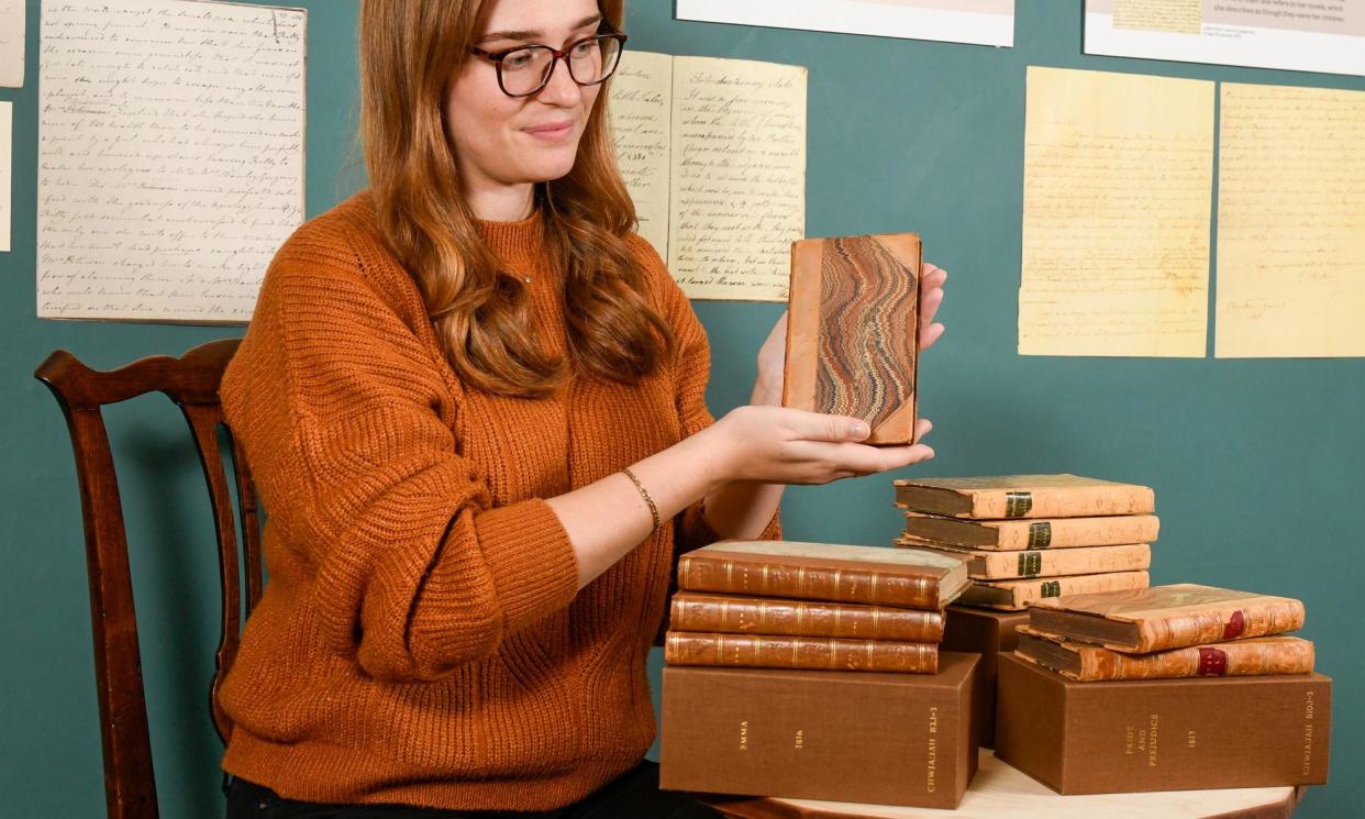 <span>Museum officer Rebecca Wood holding one of Jane Austen's Pride and Prejudice first editions.</span><span>Photograph: Andrew Croft/Solent News & Photo Agency</span>