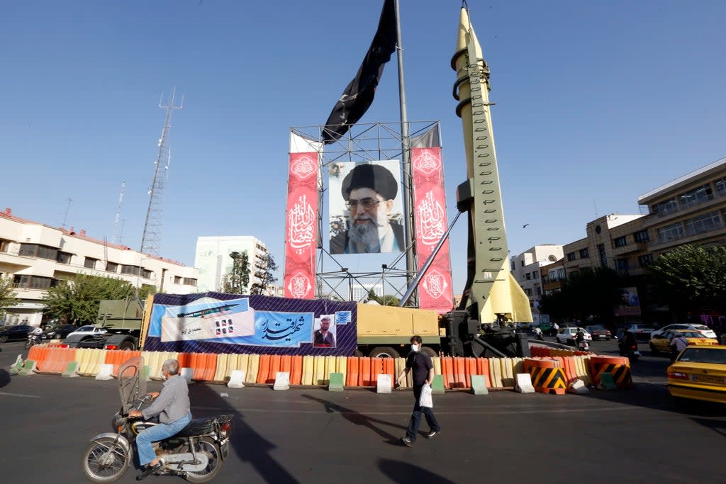 A Shahab-3 surface-to-surface missile on display next to a picture of Iranian supreme leader Ayatollah Ali Khamenei (EPA)