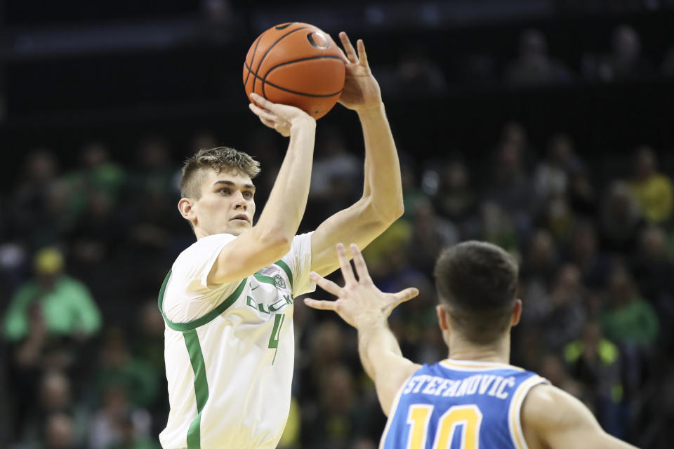 Oregon guard Brennan Rigsby (4) shoots over UCLA guard Lazar Stefanovic (10) during the first half of an NCAA college basketball game in Eugene, Ore., Saturday, Dec. 30, 2023. (AP Photo/Amanda Loman)