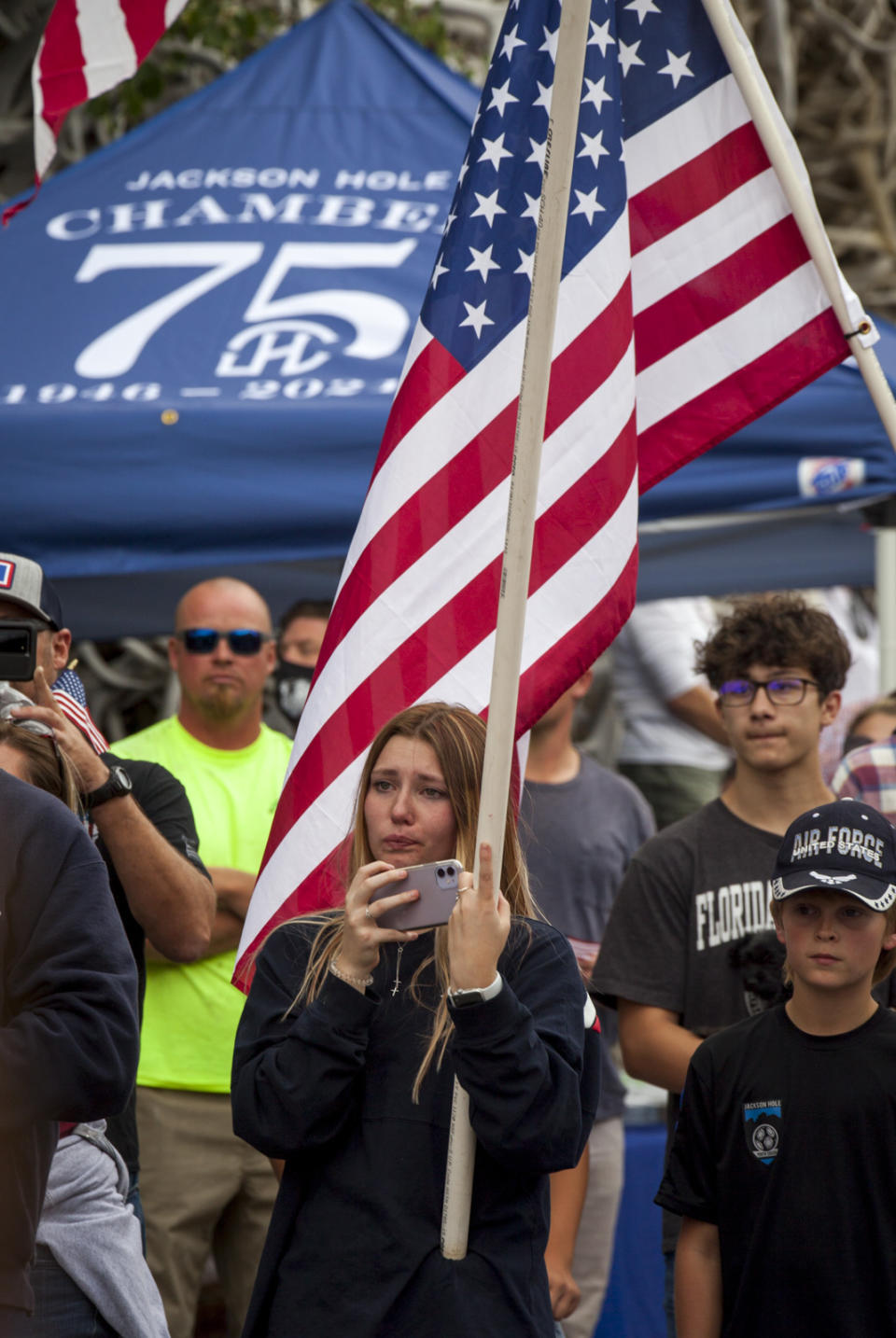 Arianna Baker, 17, pays her respects during the procession for Marine Lance Cpl. Rylee McCollum in Jackson, Wyo., Friday, Sept. 10, 2021. McCollum was one of the service members killed in Afghanistan after a suicide bomber attacked Hamid Karzai International Airport on Aug. 26. (AP Photo/Amber Baesler)