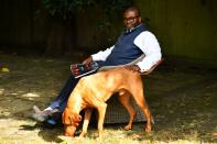 Photographer and founder of What We Seee Harriman, sits in his garden in Woking