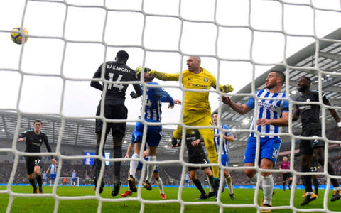 Davy Propper of Brighton and Hove Albion wins a header as Willy Caballero of Chelsea attempts to save  - Credit: Getty Images