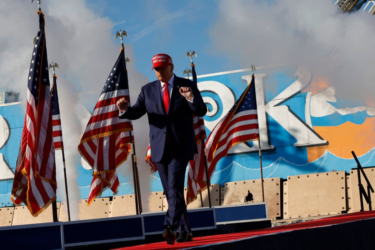 Donald Trump arrives onstage at his Wildwood, New Jersey rally in May, where members of the Proud Boys said they were in attendance to provide ‘security’  (Getty)