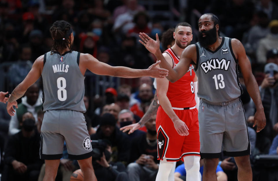 Chicago Bulls guard Zach LaVine (8) looks on as Brooklyn Nets guards Patty Mills (8) and James Harden (13) celebrate in the first half at the United Center in Chicago on Wednesday, Jan. 12, 2022.  (Chris Sweda/Chicago Tribune/Tribune News Service via Getty Images)