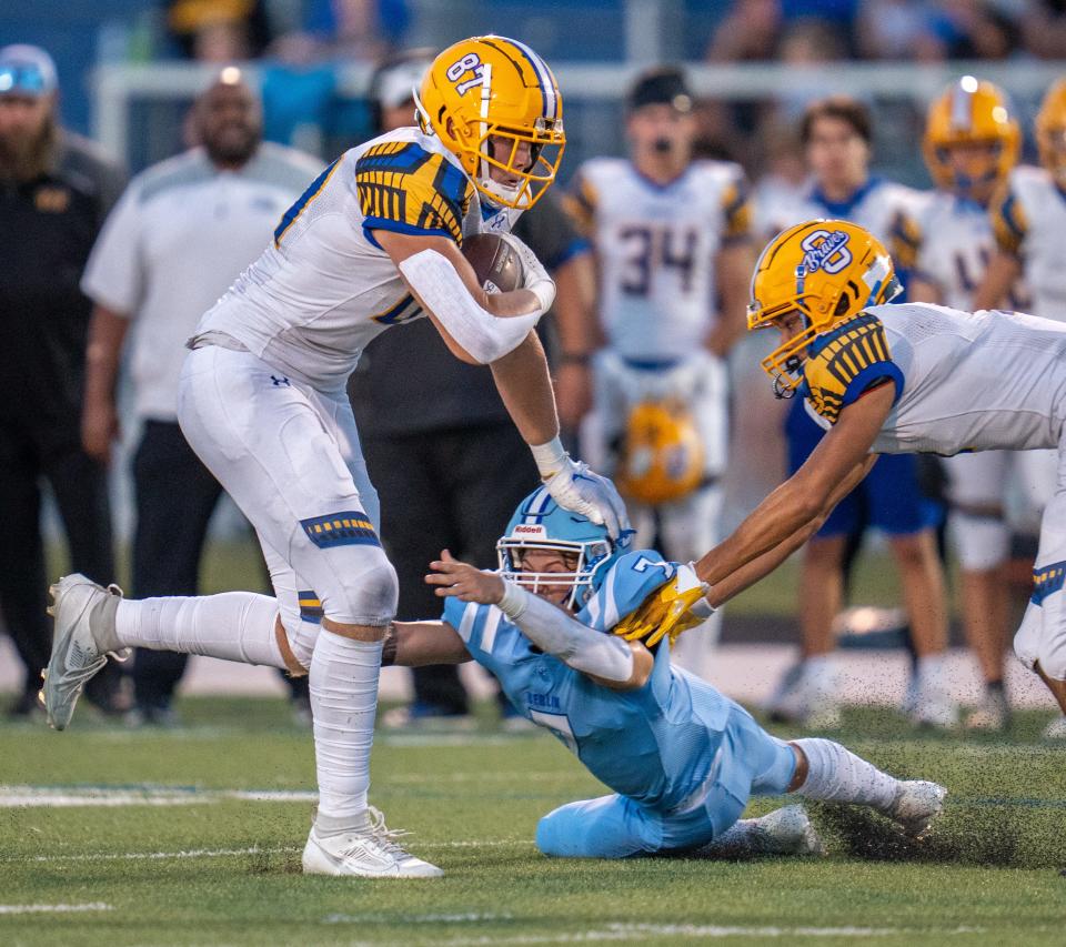 Gavin Grover (87) carries the ball for Olentangy in a high school game last September.