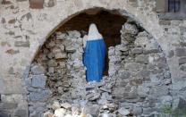 A Virgin Mary statue is seen in cemetery following an earthquake at Sant' Angelo near Amatrice, central Italy, August 26, 2016. REUTERS/Max Rossi