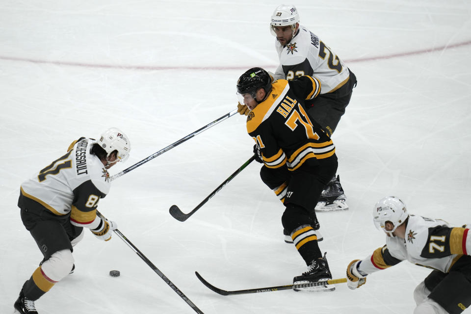 Boston Bruins left wing Taylor Hall tries to skate through the Vegas Golden Knights during the second period of an NHL hockey game, Monday, Dec. 5, 2022, in Boston. (AP Photo/Charles Krupa)