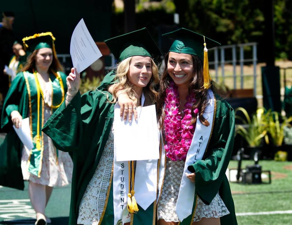 Madison Demijohn, left, a kinesiology major, and Olivia Ortiz, a biology major, celebrate on Saturday as Cal Poly honored more than 5,000 graduating students in six ceremonies on June 17 and 18, 2023, at Alex G. Spanos Stadium.