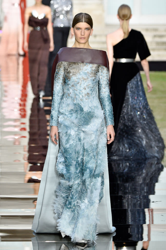 <p>Model wears a long-sleeve blue feathered gown and cape from the Givenchy fall 2018 couture collection. (Photo: Getty Images) </p>