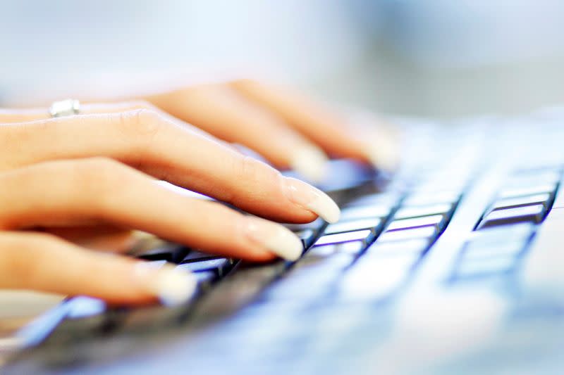 FILE PHOTO: A woman uses a computer keyboard in this photo illustration