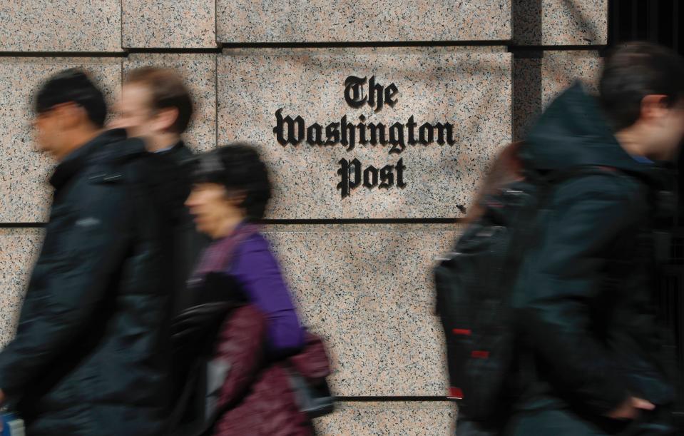 People walk by the One Franklin Square Building, home of The Washington Post newspaper, Thursday, Feb. 21, 2019 in Washington.