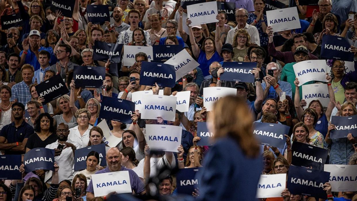 PHOTO: People raise signs in support of Vice President Kamala Harris as she speaks at a campaign event at West Allis High School in West Allis, Wisconsin, July 23, 2024.  (Kevin Mohatt/Reuters)