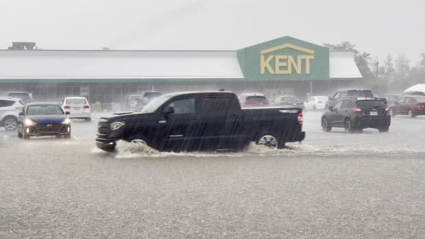 A pickup truck is shown driving through the storm in Windsor, N.S. (Robert Short/CBC - image credit)