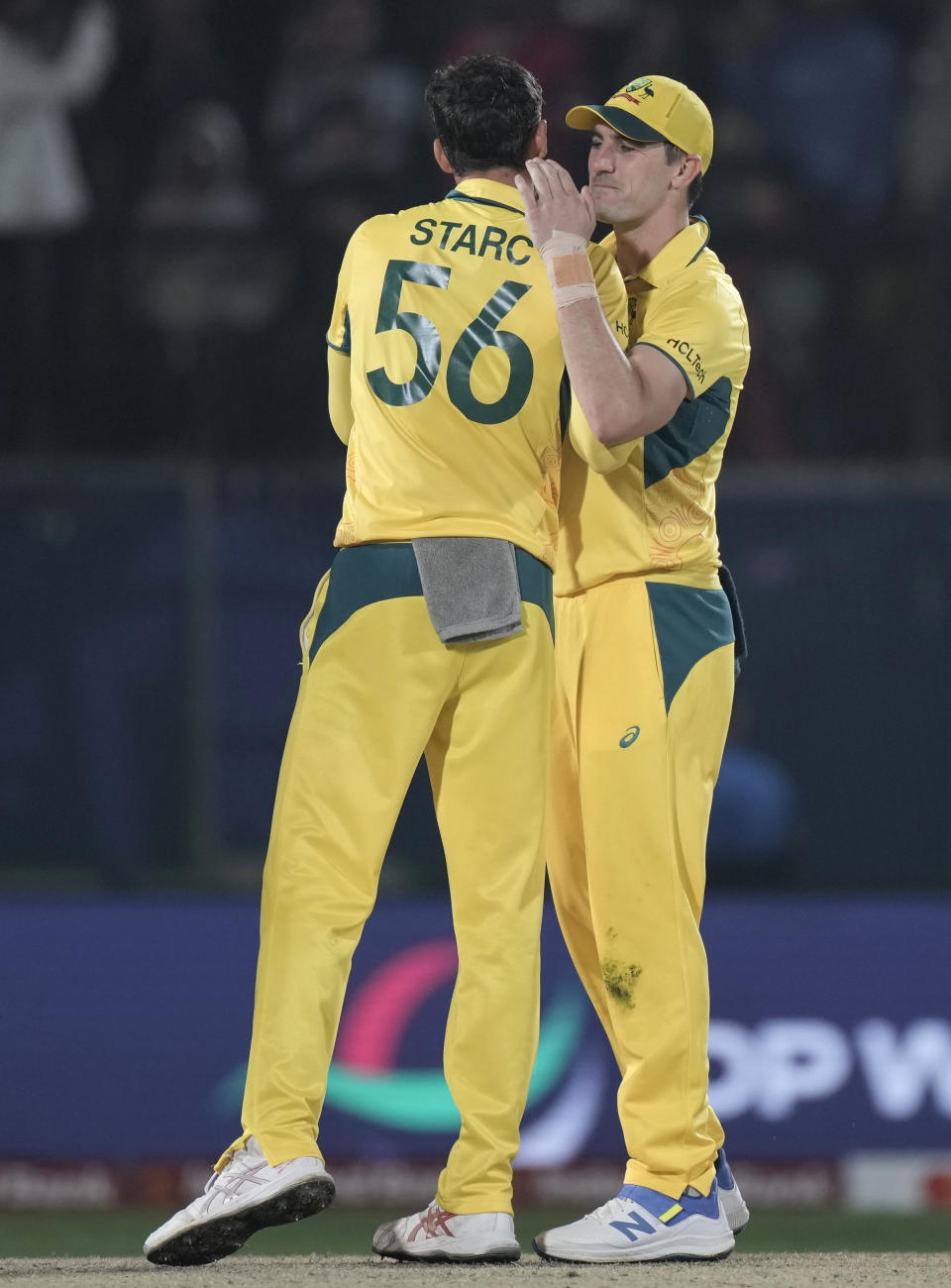 Australia's captain Pat Cummins, right congratulates Mitchell Starc after they won the ICC Men's Cricket World Cup match against New Zealand in Dharamshala, India,Saturday, Oct. 28, 2023. (AP Photo/Ashwini Bhatia)