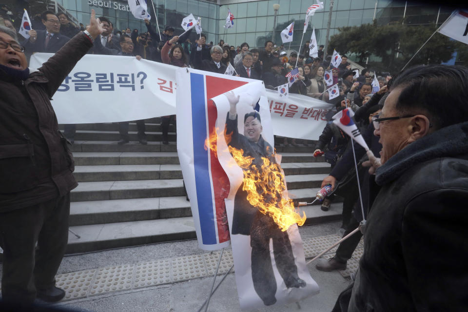 FILE - In this Jan. 22, 2018 file photo, South Korean protesters burn a portrait of North Korean leader Kim Jong Un during a rally against a visit of North Korean Hyon Song Wol, head of a North Korean art troupe, in front of Seoul Railway Station in Seoul, South Korea. Kim and South Korean President Moon Jae-in announced in the North Korean capital of Pyongyang this week that Kim has accepted Moon’s request to visit Seoul soon, maybe within the year.(AP Photo/Ahn Young-joon, File)