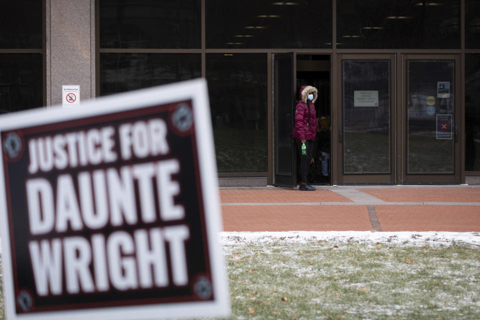 Demonstrators place a sign demanding justice for Daunte Wright outside the Hennepin County Courthouse during the trial of former Brooklyn Center police Officer Kim Potter.