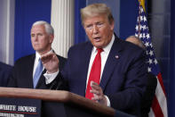 President Donald Trump speaks about the coronavirus in the James Brady Briefing Room, Tuesday, March 24, 2020, in Washington, as Vice President Mike Pence listens. (AP Photo/Alex Brandon)