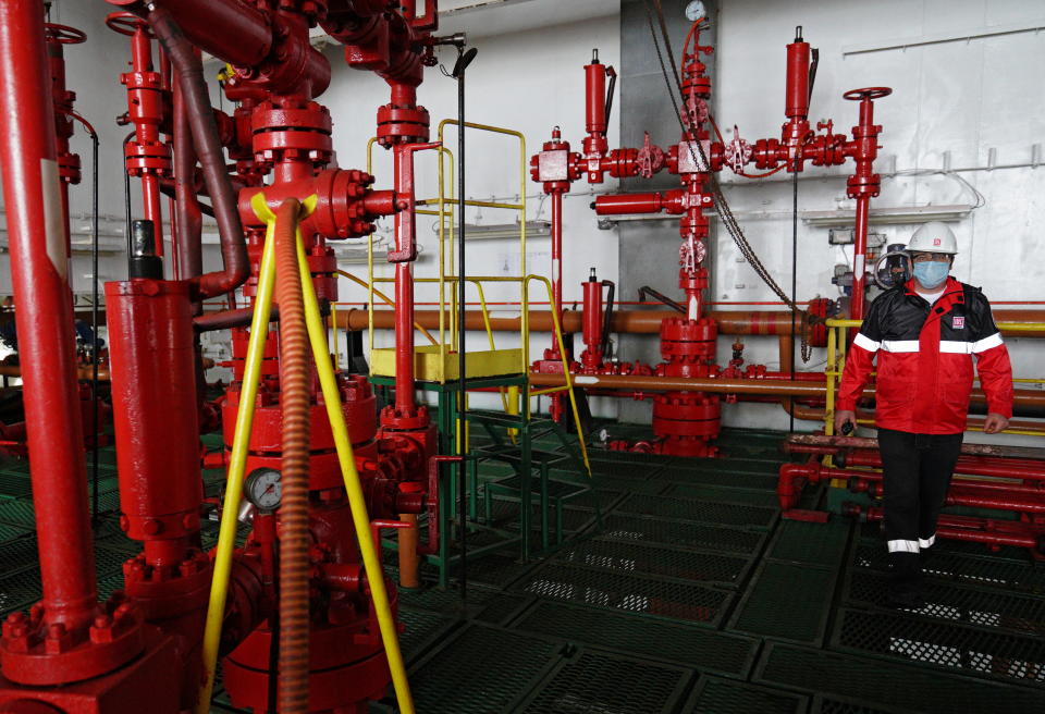 An employee is seen at an oil platform operated by Lukoil company at the Kravtsovskoye oilfield in the Baltic Sea, Russia September 16, 2021. REUTERS/Vitaly Nevar