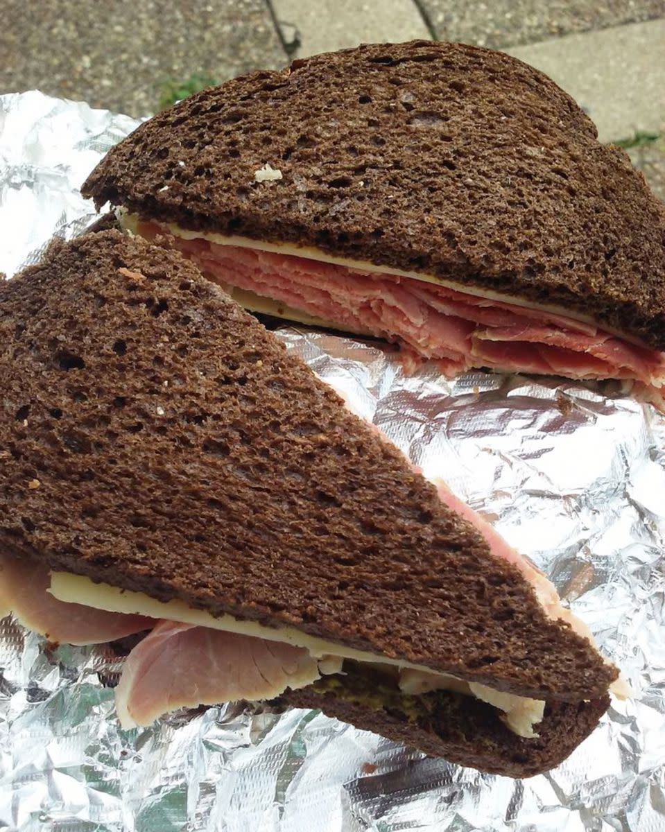 Country Ham Sandwich on aluminium paper, Morris' Deli, Louisville, Kentucky, over a brown brick walkway outside