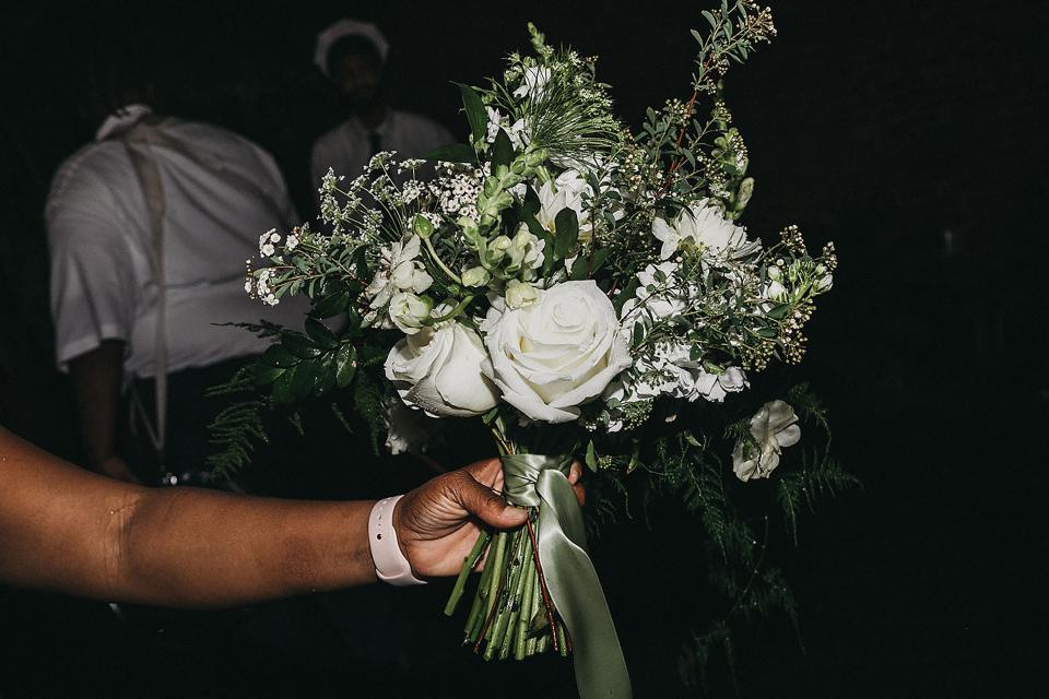 Before the bouquet toss. I didn’t want to throw mine, so we used one of the table arrangements!