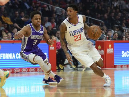 December 26, 2018; Los Angeles, CA, USA; Los Angeles Clippers guard Lou Williams (23) moves the ball against Sacramento Kings guard Yogi Ferrell (3) during the first half at Staples Center. Mandatory Credit: Gary A. Vasquez-USA TODAY Sports
