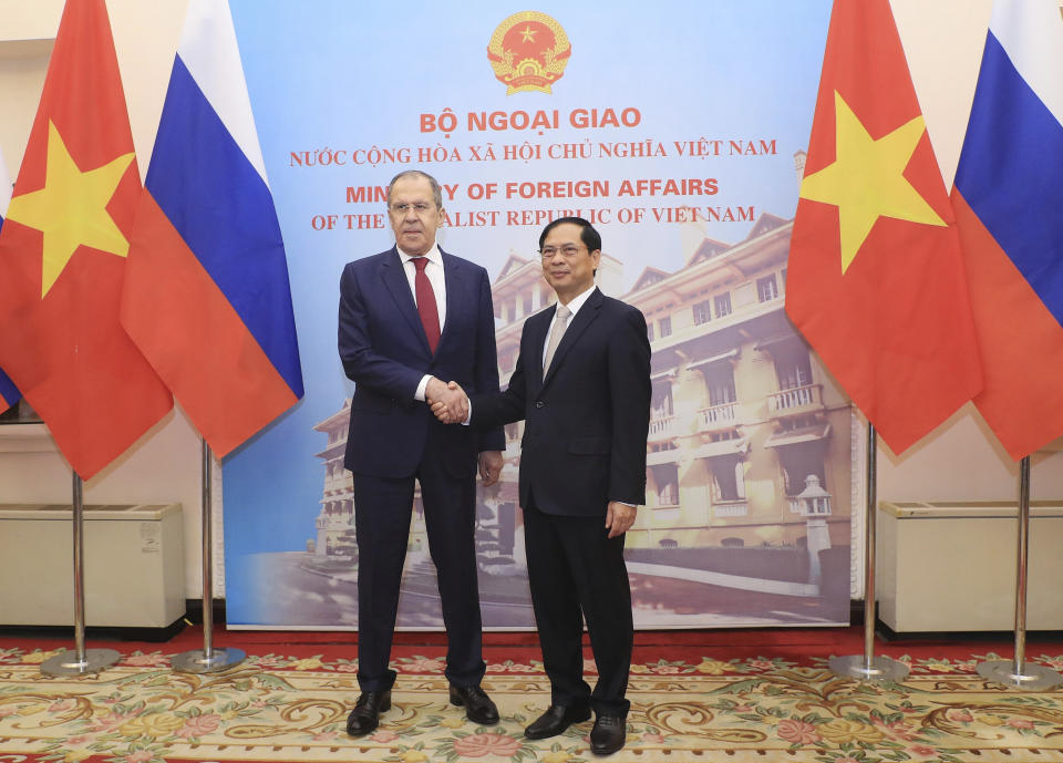 Russian Foreign Minister Sergey Lavrov, left, and Vietnamese Foreign Minister Bui Thanh Son shake hands in Hanoi, Vietnam on Wednesday, July 6, 2022. Lavrov is on a trip to Asia to seek support amid his country's diplomatic isolation by the West and punishing sanctions leveled over its invasion of Ukraine. (Bui Lam Khanh/VNA via AP)