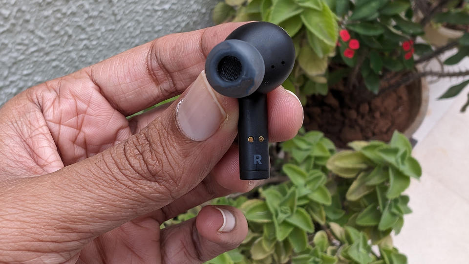 Belkin SoudForm Pulse wireless earbuds held in hand