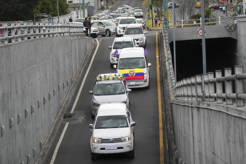 A hearse, second from below, carrying the body of slain presidential candidate Fernando Villavicencio, drives in a funeral procession to the cemetery for his burial in Quito, Ecuador, Friday, Aug. 11, 2023. The 59-year-old was fatally shot at a political rally on Aug. 9 in Quito. (AP Photo/Dolores Ochoa)