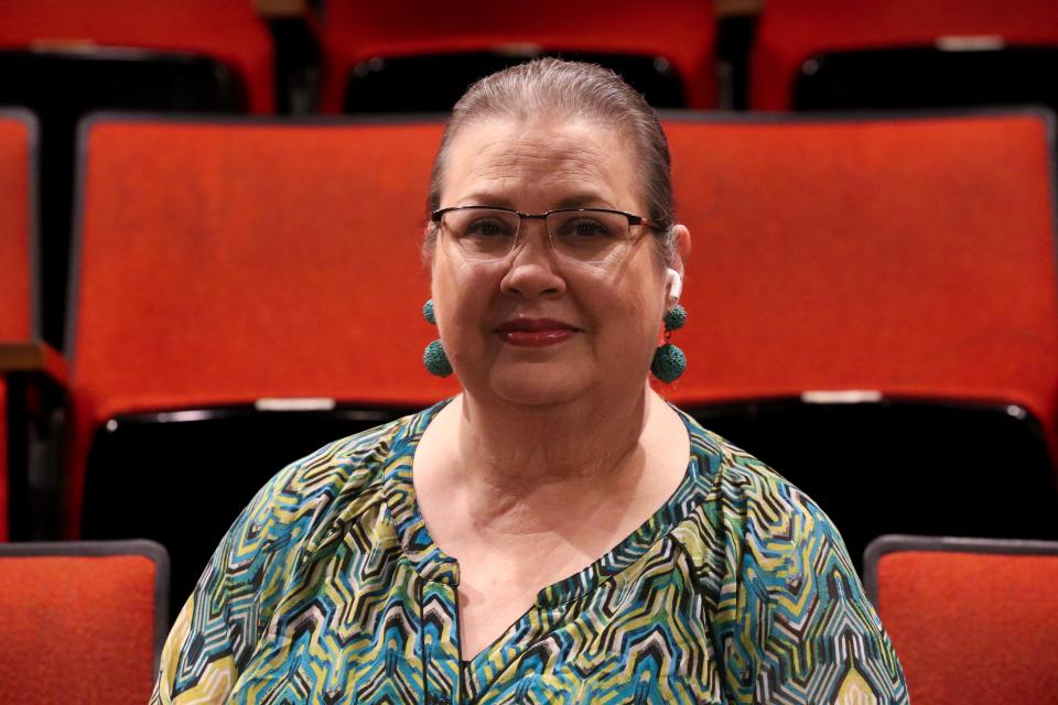 Mary Chapa, owner and executive director of Aurora Arts Theatre, poses inside the community theater Monday, Feb. 19, 2024.