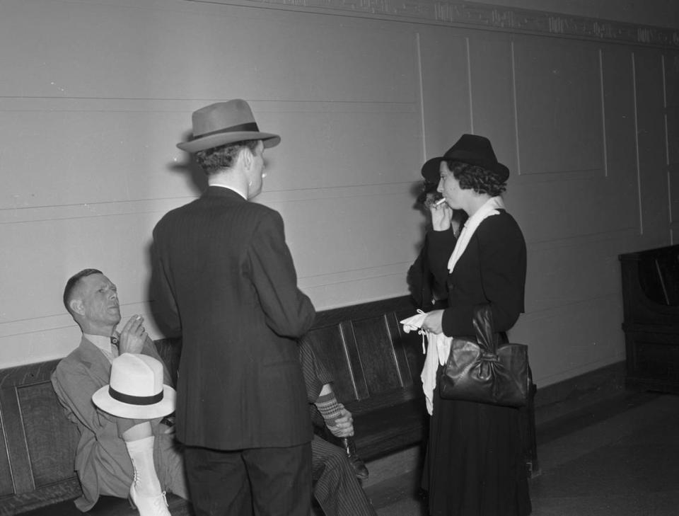 Phil and May Chadwick turn their backs to the camera during a break in their federal narcotics trial at the United States Courthouse in Fort Worth, June 1940.